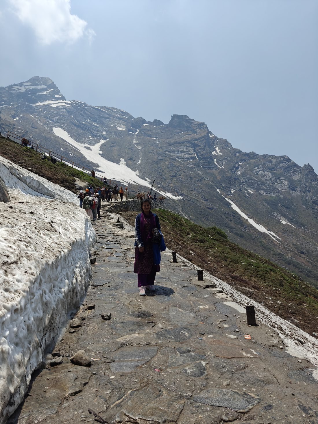 Valley of Flowers and Hemkund Sahib trek — trekkers on the stone-step trail to Hemkund Sahib past snow patches, Uttarakhand